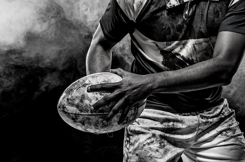 Dynamic rugby player graphic symbolizing the intense energy of 6 Nations at The Plough, Brackley.